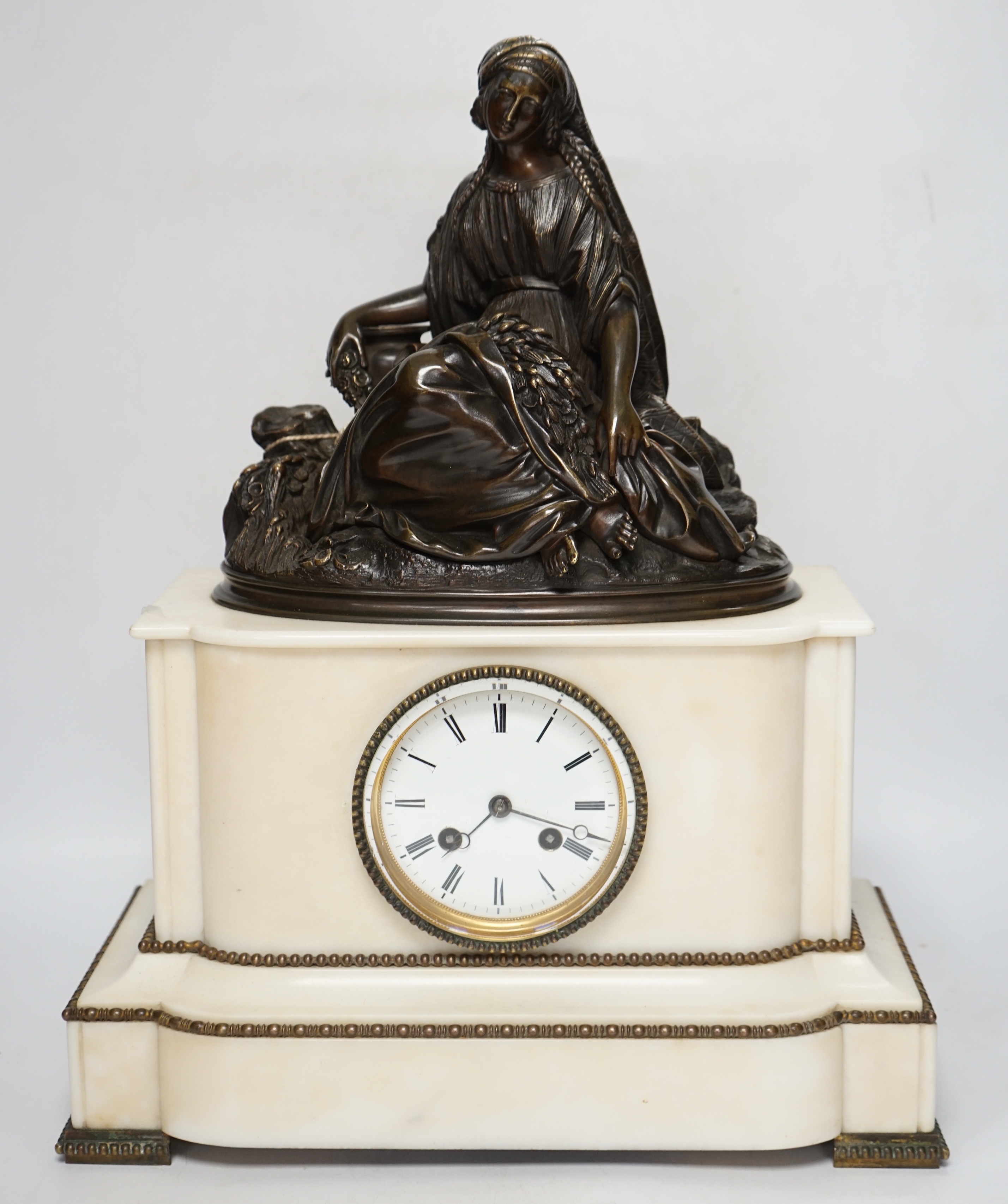 A late 19th century French figural bronze mounted white marble mantel clock, 42cm